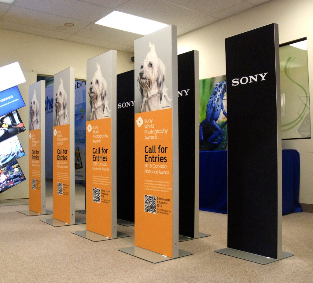 Slim fabric LED lightboxes in two rows, featuring a graphic of a dog and bright orange background with text